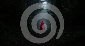 Person in Red Cape Walking Dark Forest Path