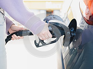 Person Refueling Car at Gas Station