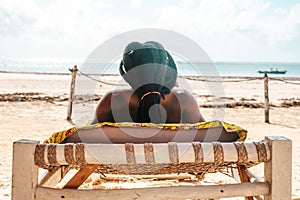 Person relaxing on the deckchair at sea