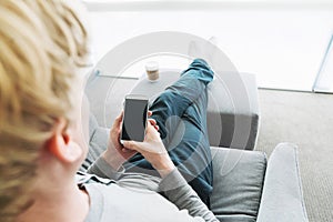 Person relaxing and using smart phone