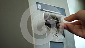 Person removing credit card from ATM, confirming completion of banking operation