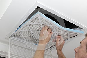 Man Removing Dirty Air Filter photo