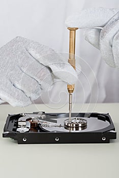Person Repairing Harddisk Using Screwdriver