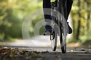 Person riding a bicycle along a fall road