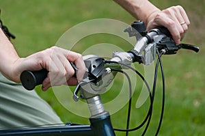 Person riding a bicycle holding bicycle s handlebars