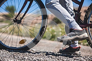 A person is riding a bicycle with their feet on the pedals