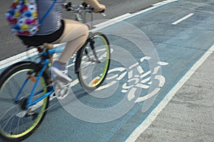 Person riding a bike on bicycle lane or cycle path outdoors photo