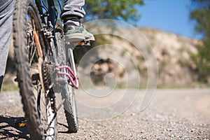 A person is riding a bike with their feet on the pedals