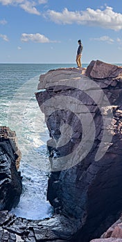 Person on the rocks above Thunder Hole in Acadia National Park