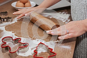 a person rolling out dough shapes on a counter top with dough cutters