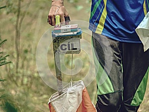 Person run to check point. Outdoor orienteering check point