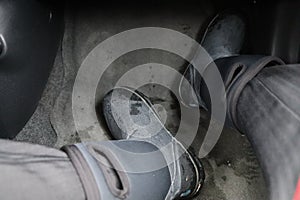 A person`s black boots in the car