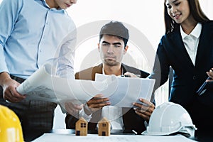 Person's engineer Hand Drawing Plan On Blue Print with architect equipment, Architects discussing at the table.