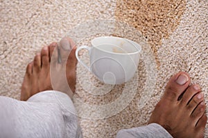 Person`s Feet Standing Near Spilled Coffee