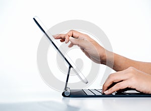 Person`s finger touching, drawing on digital tablet screen while typing on keyboard computer.