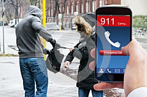 Person's Hand Dialing Emergency Call On Mobile Phone