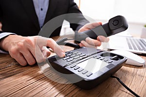 Person`s Hand Dialing Telephone Number To Make Phone Call