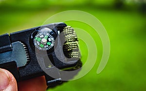 person's hand with compass in the forest photo