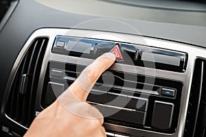 Person's hand pressing emergency button