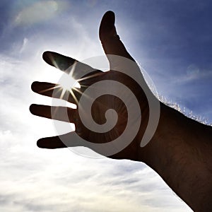 Person's Hand Reaching Towards Heaven Sunlight