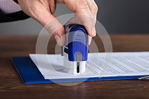 Person`s Hand Stamping Document