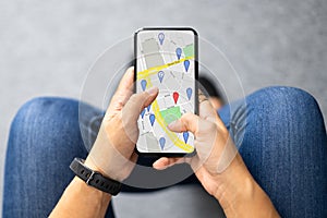 Person's Hand Using GPS Navigation Map
