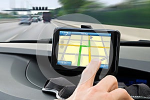 Person's Hand Using Gps Navigation System In Car