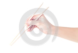 Person `s right hand using bamboo chopsticks