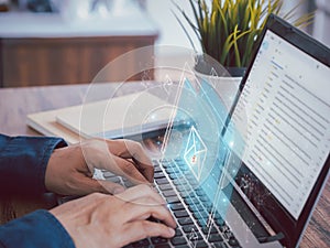 Person send or receive e-mail from notification icon by laptop.