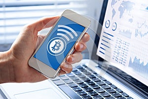 Person sending bitcoin with smartphone for online payment, business, screen