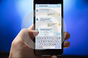 Person Sending Text Message From Mobile Phone
