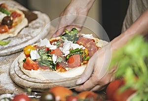 Person serving a homemade pizza