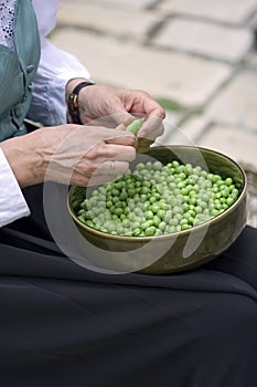 Person shelling green beans