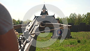 Person shooting with mediavel wooden crossbow.