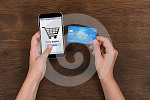 Person Shopping Online With Credit Card On Mobile Phone