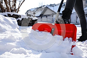Person shoveling snow outdoors on winter day  closeup