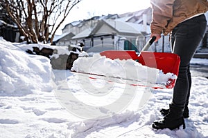 Person shoveling snow outdoors on winter day  closeup