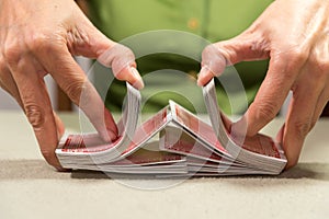 person shuffling cards for a card game