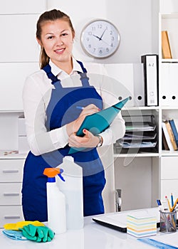 Person is signing documents while cleaning