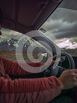 Person sitting in car at Torres del Paine National Park, Patagonia, Chile