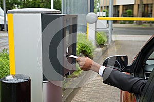 Person Sitting In Car Using Parking Machine