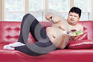 Person sitting on sofa with donuts