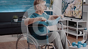 Person sitting in wheelchair and pulling resistance band to stretch