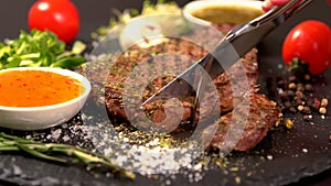 Person slicing a tender rump steak with a knife