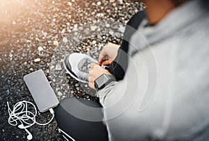 Person, smartphone and shoelace with running or exercise for fitness, health and wellbeing in outdoor. Above, sneakers