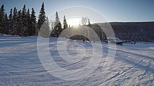 Person snowboarding from a snowy slope. Snowboarder on board rides a mountain.