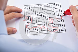 Person Solving Maze Puzzle