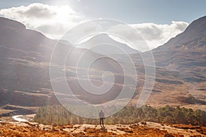 Person standing against the background of Torridon hills. Scotland