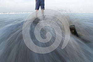 Person standing alone with confidence on the beach slow motion. Life challenge, spirituality and strength concept