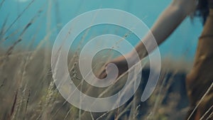 Person standing in a field with tall grass, evoking a sense of tranquility and connection with nature